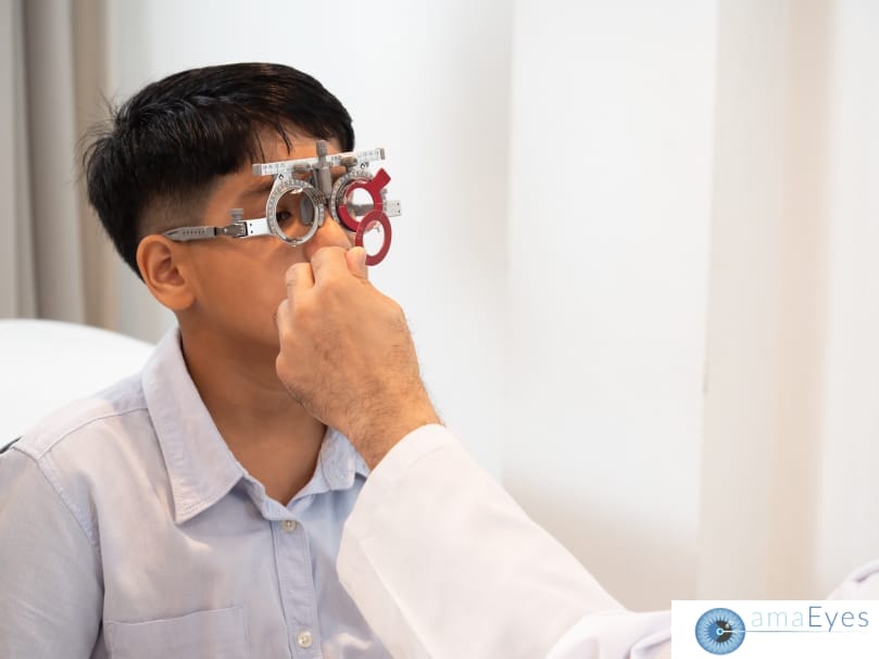 Young boy undergoing an eye check-up at a pediatric clinic, with a doctor using an eye examination tool to assess his vision.